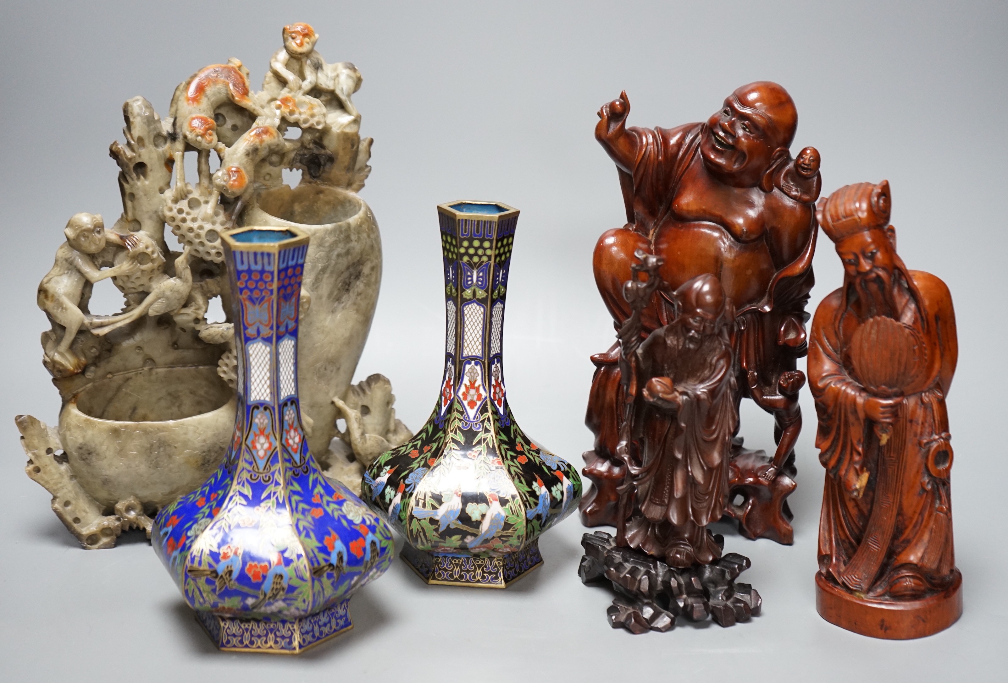 Two Chinese champlevé enamel vases, a soapstone carving and three early 20th century Chinese carved hardwood figures, tallest 26cm